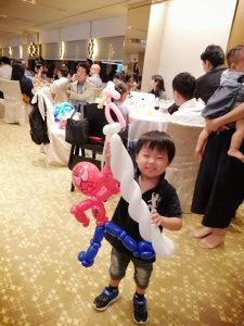 child holding a spiderman balloon