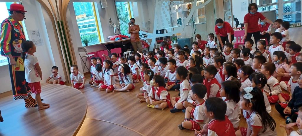 children sitting together to watch a kids magic show